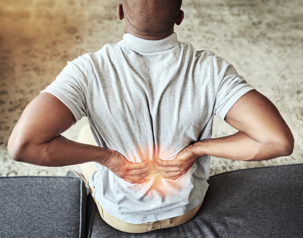 A black man having recurring back pain