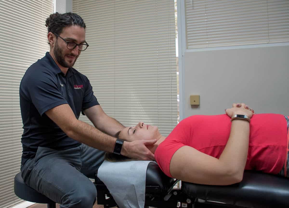 Chiropractor's office session with patient